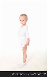 little girl doing gymnastics against white background