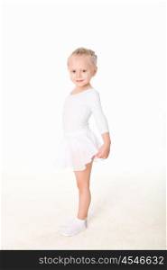 little girl doing gymnastics against white background
