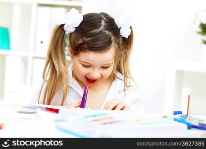 Little girl drawing and studying at home