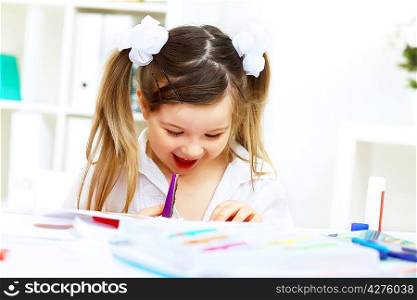 Little girl drawing and studying at home