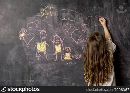 little girl drawing family blackboard