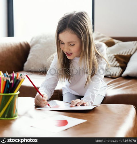 little girl drawing father s day card as surprise her dad