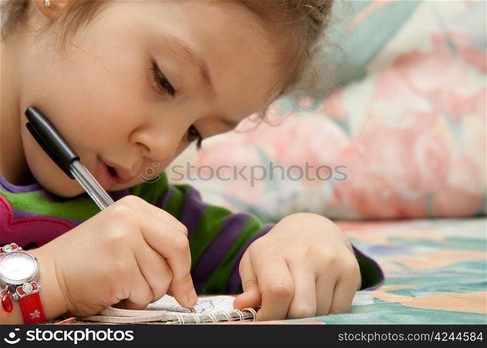 Little Girl Drawing Flowers On A Notebook