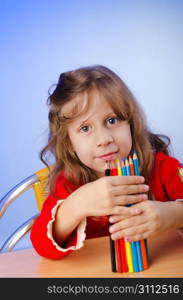 Little girl drawing with pencils