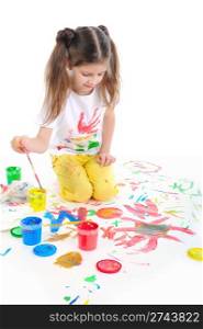 Little girl draws a colored paint sitting on the floor
