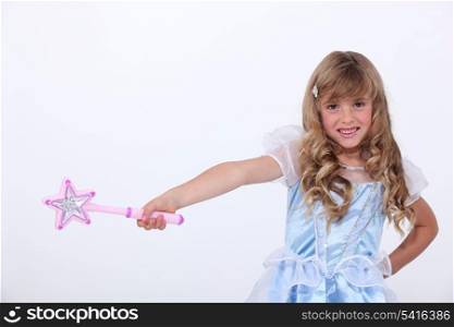 Little girl dressed as princess with wand