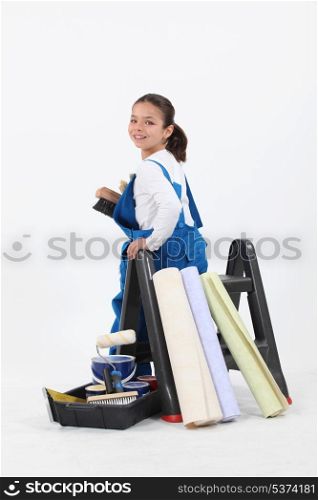 little girl dressed in house painter