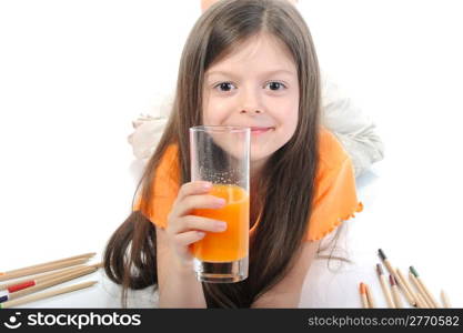 Little girl drinking juice lying on the floor. Isolated on white background