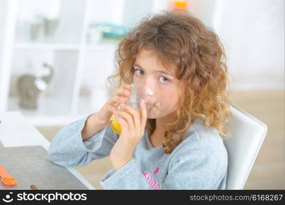 Little girl drinking orange juice