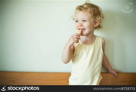 Little girl eating a cookie