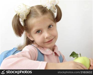 Little girl eating an apple