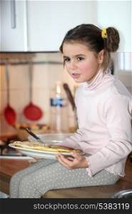little girl eating at the kitchen