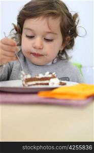 little girl eating cake