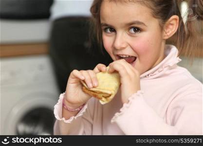 Little girl eating pancake