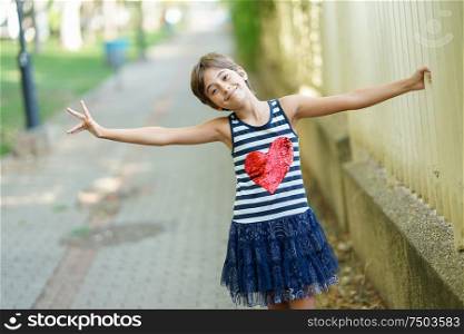 Little girl, eight years old, having fun in an urban park.. Little girl, eight years old, having fun outdoors.
