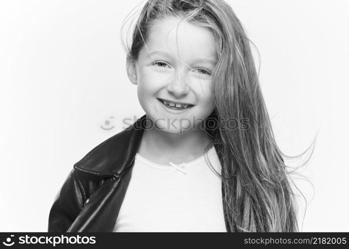 Little girl expressing joy and emotion through her body, her face while keeping the cute effect she wears with her fashion that is well on trend.