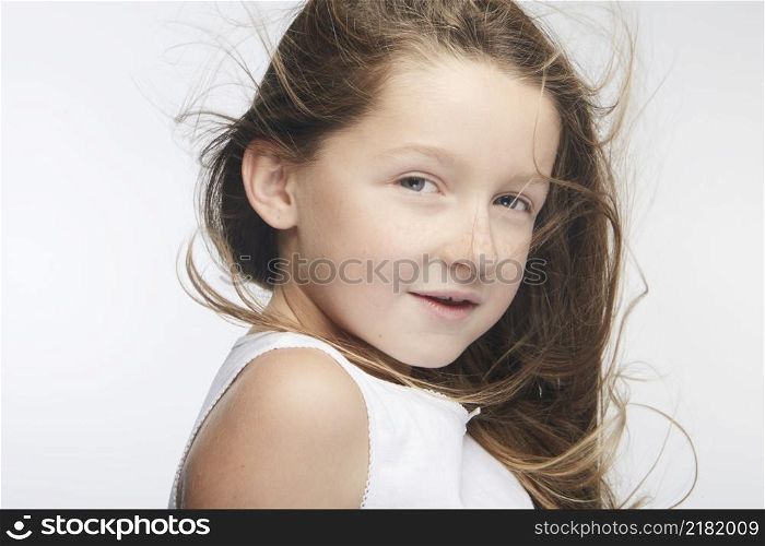 Little girl expressing joy and emotion through her body, her face while keeping the cute effect she wears with her fashion that is well on trend.