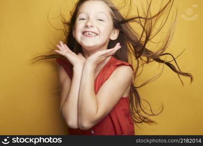 Little girl expressing joy and emotion through her body, her face while keeping the cute effect she wears with her fashion that is well on trend.