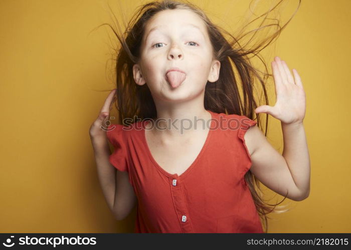 Little girl expressing joy and emotion through her body, her face while keeping the cute effect she wears with her fashion that is well on trend.