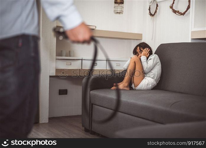 Little girl fearing her parents from punishing on sofa in dramatic moment. Children's Rights in Early Childhood Education and Social issues and parents care problem concept. Child disorder and abuse