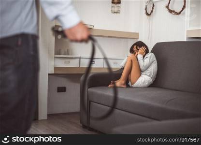 Little girl fearing her parents from punishing on sofa in dramatic moment. Children's Rights in Early Childhood Education and Social issues and parents care problem concept. Child disorder and abuse