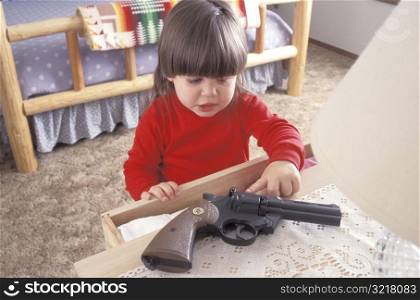 Little Girl Finding a Gun