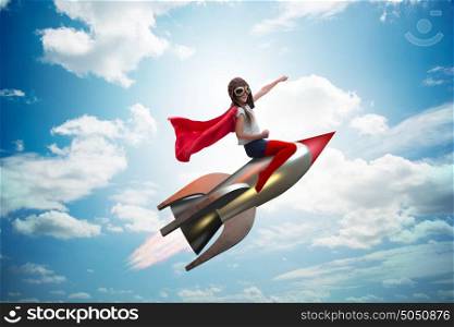Little girl flying rocket in superhero concept