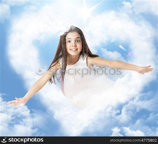 Little girl flying through a heartshaped cloud
