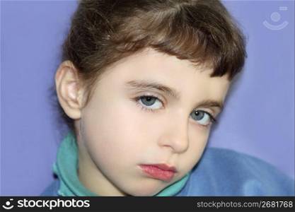 Little girl gesture portrait looking camera blue eyes and purple background