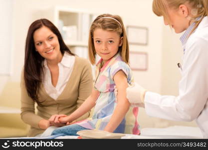 Little girl getting vaccination from pediatrician at office