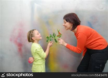 little girl giving gift to mother