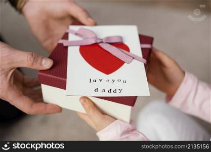 little girl giving her father gift box father s day