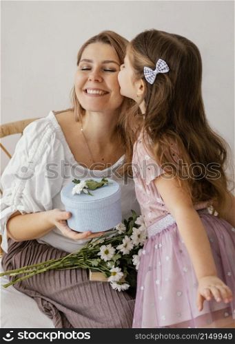 little girl giving spring flowers gift box her mom mother s day
