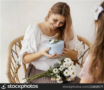 little girl giving spring flowers gift box her mother