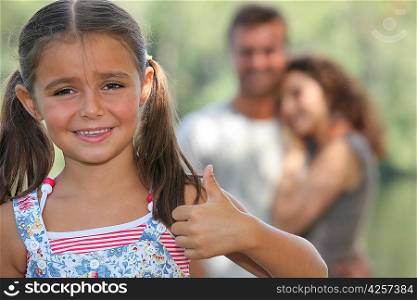 Little girl giving thumbs-up gesture