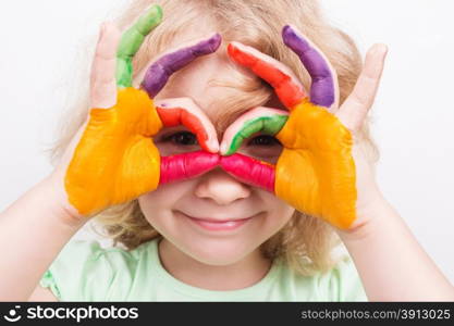 Little girl hands painted in colorful paints