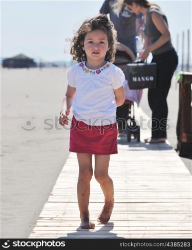 little girl have fun and play on the beach