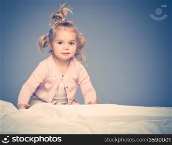 Little girl having fun on bed