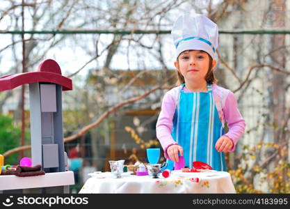 Little girl having fun playing cooking