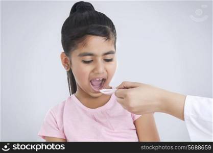 Little girl having medicine