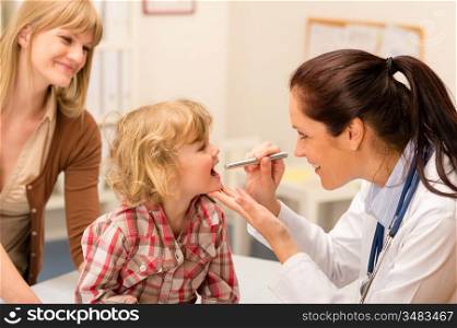 Little girl having throat examination by pediatrician using light pen