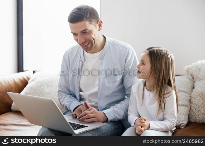 little girl her father spend time laptop