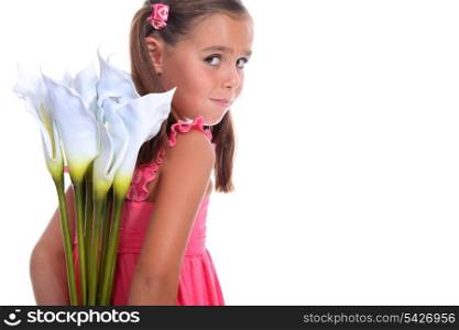 little girl hiding flowers behind her back