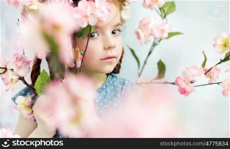 Little girl holding a colorful branch