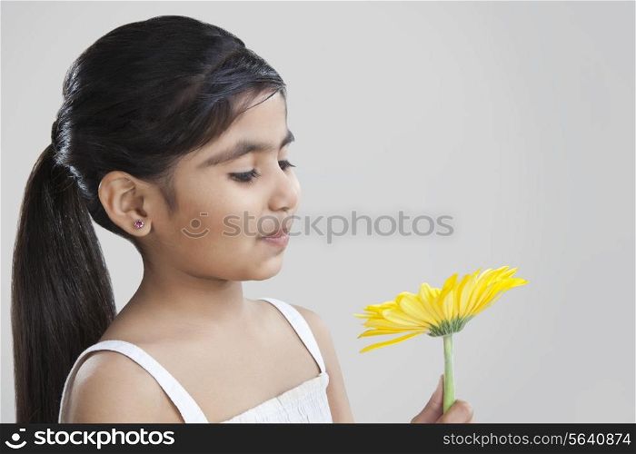 Little girl holding a flower