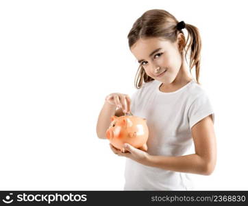 Little girl holding a piggy-bank and inserting a one euro coin