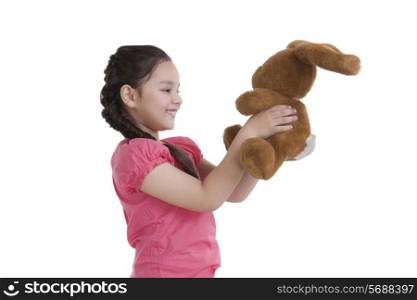 Little girl holding a toy rabbit