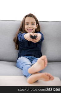 Little girl holding a TV remote control