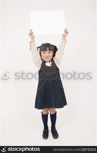 little girl holding a white board