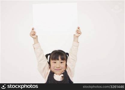 little girl holding a white board